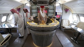 People walk inside of the 100th Emirates Airline double-decker Airbus A380, the worlds largest passenger aircraft, during the 2018 Bahrain International Airshow (BIAS) at the Sakhir Airbase, south of the Bahraini capital Manama on November 14 2018. (