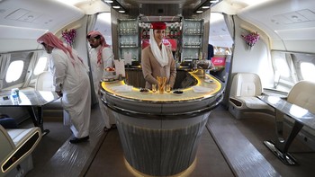 People walk inside of the 100th Emirates Airline double-decker Airbus A380, the worlds largest passenger aircraft, during the 2018 Bahrain International Airshow (BIAS) at the Sakhir Airbase, south of the Bahraini capital Manama on November 14 2018. (