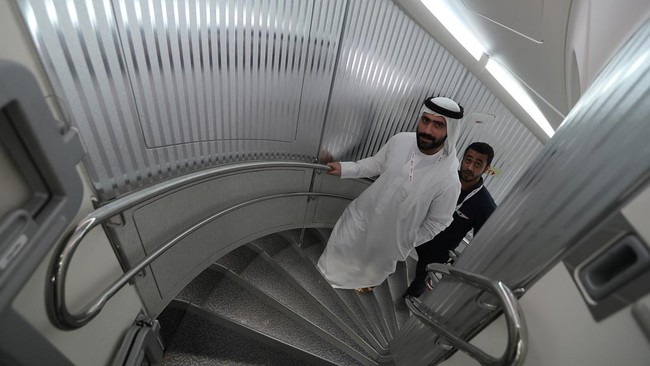 People walk inside of the 100th Emirates Airline double-decker Airbus A380, the worlds largest passenger aircraft, during the 2018 Bahrain International Airshow (BIAS) at the Sakhir Airbase, south of the Bahraini capital Manama on November 14 2018. (