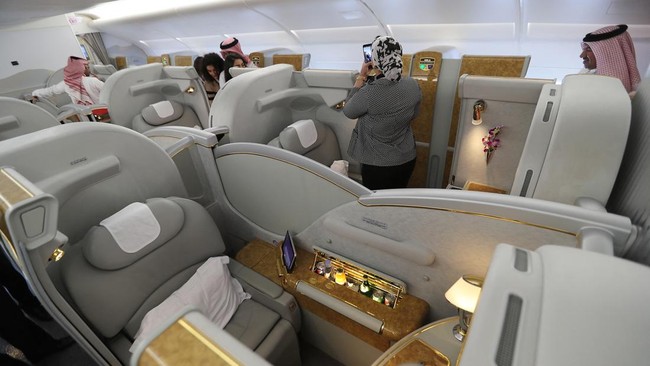 People walk inside of the 100th Emirates Airline double-decker Airbus A380, the worlds largest passenger aircraft, during the 2018 Bahrain International Airshow (BIAS) at the Sakhir Airbase, south of the Bahraini capital Manama on November 14 2018. (