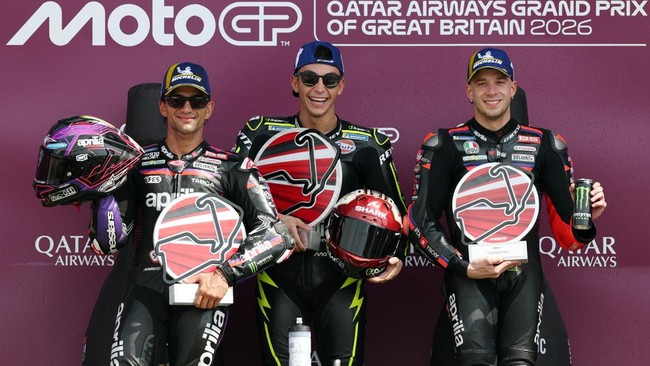 MotoGP - British Grand Prix - Silverstone Circuit, Silverstone, Britain - August 9, 2026 SuperFile Trackhouse MotoGP Team's Raul Fernandez celebrates with his trophy on the podium after winning the MotoGP race along with second placed Aprilia Racing'