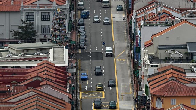 Cars pass along a road in Singapore on June 1, 2026. (Photo by Jam STA ROSA / AFP)