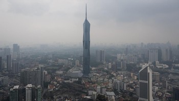 Warisan Merdeka Tower (KL118) (C) and commercial buildings are covered in haze in Kuala Lumpur on August 11, 2026, as authorities in Malaysia warned of high levels of air pollution from regional wildfires. The Malaysian Meteorological Department urge
