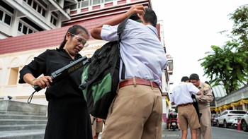 Teachers use metal detectors to screen for weapons and check students' bags as they enter a school in Bangkok, following a deadly shooting at Debsirin Nonthaburi School in Nonthaburi province on the outskirts of Bangkok, Thailand, August 10, 2026. RE