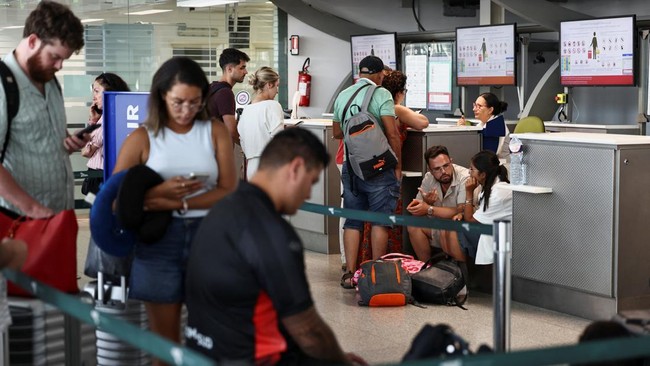 Passengers wait inside the terminal at Vincenzo Bellini Catania Airport following the closure of the airport due to an ash cloud from Sicilys Mount Etna eruption in Catania, Italy, August 14, 2026. REUTERS/Matteo Minnella