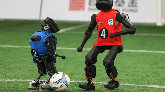 Humanoid robots play soccer during a training session as part of a media tour, ahead of the 2026 World Humanoid Robot Games in Beijing, China, August 14, 2026. REUTERS/Maxim Shemetov