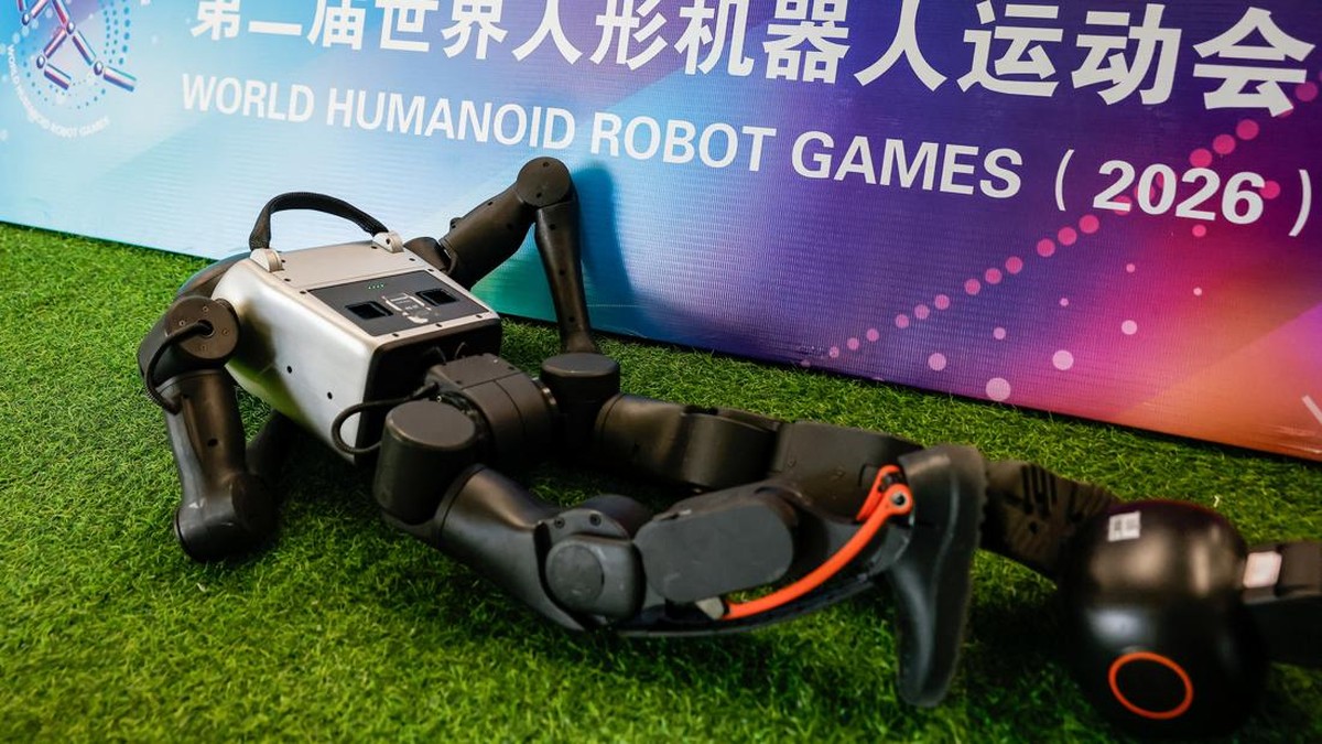 A Booster Robotics humanoid robot lies down at a training session as part of a media tour, ahead of the 2026 World Humanoid Robot Games in Beijing, China, August 14, 2026. REUTERS/Maxim Shemetov