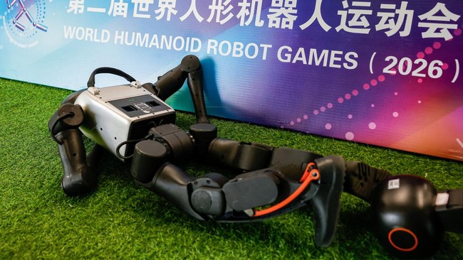 A Booster Robotics humanoid robot lies down at a training session as part of a media tour, ahead of the 2026 World Humanoid Robot Games in Beijing, China, August 14, 2026. REUTERS/Maxim Shemetov