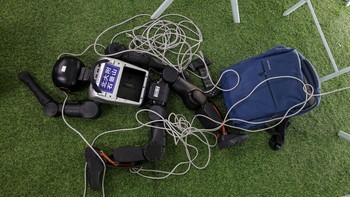 A Booster Robotics humanoid robot lies down at a training session as part of a media tour, ahead of the 2026 World Humanoid Robot Games in Beijing, China, August 14, 2026. REUTERS/Maxim Shemetov