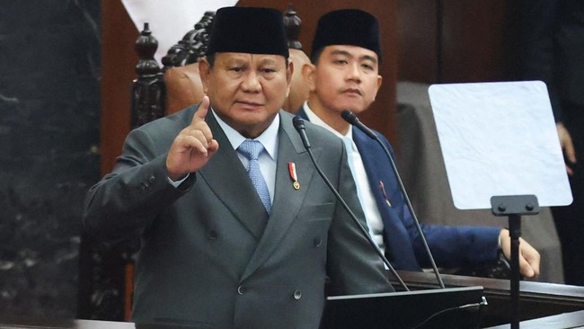 Indonesian President Prabowo Subianto gestures as he delivers his annual state of the nation address before the members of Parliament, while Vice President Gibran Rakabuming Raka sits next to him, ahead of the country's 81st Independence Day, in Jaka