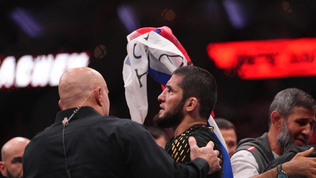 Aug 15, 2026; Philadelphia, Pennsylvania, USA; Islam Makhachev (red gloves) celebrates after defeating Iah Machado Garry (blue gloves) in the welterweight title bout during UFC 330 at Xfinity Mobile Arena. Mandatory Credit: Kyle Ross-Imagn Images