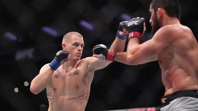 Aug 15, 2026; Philadelphia, Pennsylvania, USA; Islam Makhachev (red gloves) fights against Iah Machado Garry (blue gloves) in the welterweight title bout during UFC 330 at Xfinity Mobile Arena. Mandatory Credit: Kyle Ross-Imagn Images