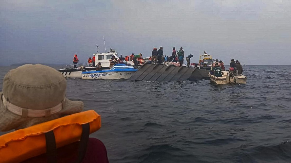 Rescue workers and local boat operators take part in ongoing search and recovery operations near the overturned passenger ferry on Lake Kariba, a day after the vessel capsized, in Kariba, Zimbabwe, August 12, 2026. REUTERS/Admore Mbonda PICTURE TAKEN