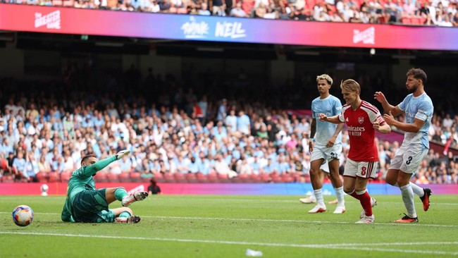 Soccer Football - FA Community Shield - Arsenal v Manchester City - Principality Stadium, Cardiff, Wales, Britain - August 16, 2026 Arsenal's Martin Odegaard scores their third goal past Manchester City's Gianluigi Donnarumma REUTERS/Chris Radburn