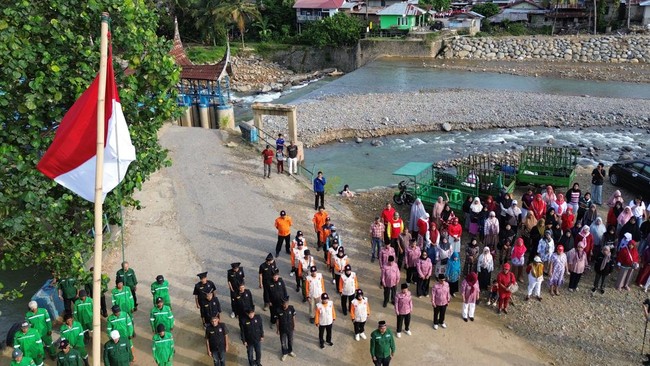 Warga penyintas bencana mengikuti upacara bendera memperingati HUT Kemerdekaan ke-81 RI di kawasan irigasi Gunung Nago, Pauh, Padang, Sumatera Barat, Senin (17/8/2026). Penyintas bencana yang masih tinggal di huntara bersama Lembaga Pengelola Sampah