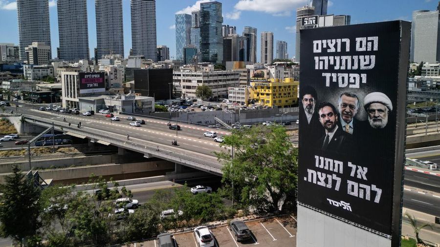 A drone view of an election billboard by Benjamin Netanyahu's Likud Party depicting Iran's Supreme Leader Mojtaba Khamenei, New York City Mayor Zohran Mamdani, Turkish President Tayyip Erdogan and Hezbollah chief Naim Qassem and a text in Hebrew that