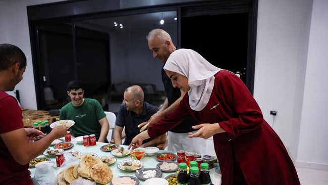 Roqaya Hassan, who was expelled from her home by the Israeli military after it was besieged by militant settlers, prepares a meal to share with neighbors in Qusra, in the Israeli-occupied West Bank, August 17, 2026. REUTERS/Ammar Awad