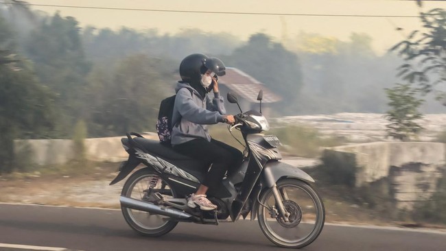 Asap karhutla menyelimuti permukiman di sepanjang tepi Sungai Kahayan di Palangkaraya, Kalimantan Tengah, Jumat (21/8).
