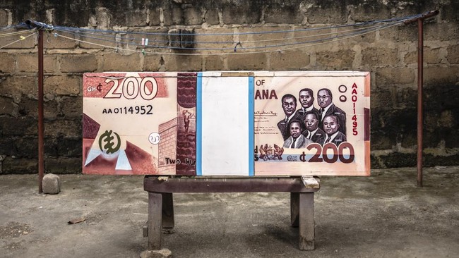 A coffin designed in the shape of a 200 Ghana cedi banknote, in reference to the profession of the deceased, a banker, is pictured near the Kane Kwei Carpentry Workshop in Accra, on August 17, 2026. Fantasy coffins are a distinctive Ghanaian funerary