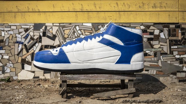 A shoe-shaped coffin, designed in reference to the profession of the deceased, a footballer, is pictured near the Erico Carpentry Shop in Accra, on August 17, 2026. Fantasy coffins are a distinctive Ghanaian funerary tradition, particularly associate