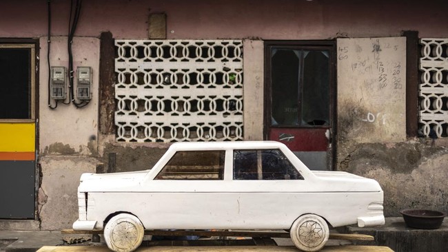 A car-shaped coffin, designed to replicate a car model owned by the deceased, is pictured at the Kane Kwei Carpentry Workshop in Accra, on August 17, 2026. Fantasy coffins are a distinctive Ghanaian funerary tradition, particularly associated with th