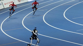 A Tiangong Ultra humanoid robot runs ahead of Honor's humanoid robots at the 400m large-size group final race, during the second World Humanoid Robot Games at the National Speed Skating Oval in Beijing, China August 23, 2026. REUTERS/Florence Lo