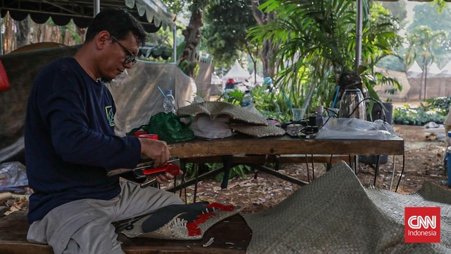 Sejumlah pekerja menata persiapan Pameran Flora dan Fauna (Flona) 2026 di Lapangan Banteng, Jakarta, Minggu (23/8). (CNN Indonesia/Febria Adha L)