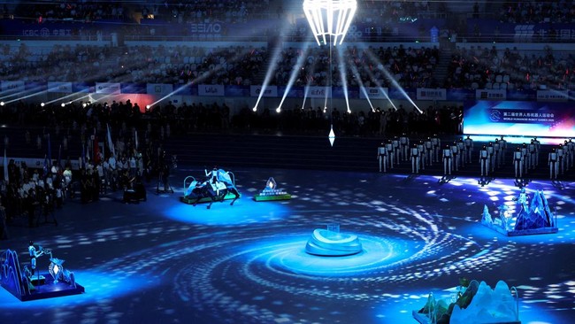 Spectators watch the opening ceremony for the second World Humanoid Robot Games at the National Speed Skating Oval in Beijing, China August 22, 2026. REUTERS/Florence Lo