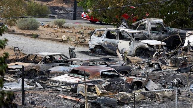 Charred remains of vehicles after the Hawk Fire burned through a neighborhood in Reno, Nevada, U.S., August 24, 2026. REUTERS/Fred Greaves