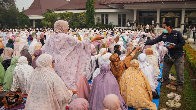 A volunteer distributes free face masks as Muslims attend mass prayers for rains, amid prolonged dry season and haze due to wildfires, in Palembang, South Sumatra province, Indonesia, August 25, 2026. REUTERS/Abriansyah Liberto
