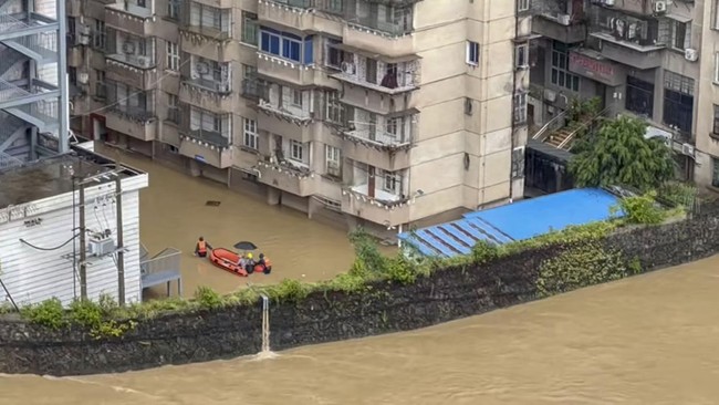 Rescuers move people on an inflatable boat through a flooded street in the aftermath of floods caused by tropical cyclone Gaenari in Longyan, Fujian Province, China, in this still image obtained from a social media video released on August 25, 2026.