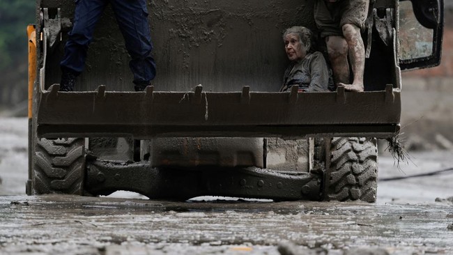 A survivor is transported to a safer place in a JCB following a flash flood at Trishuli in Nuwakot district, Nepal, August 26, 2026. REUTERS/Navesh Chitrakar