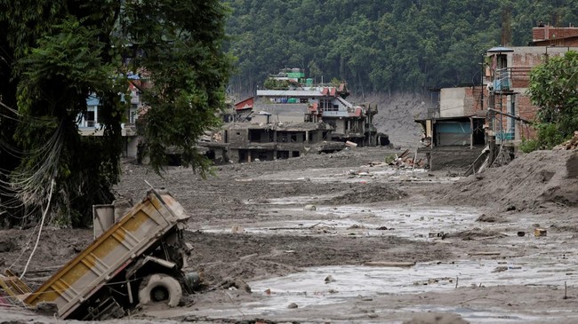 Mud covers houses and a road following a flash flood at Trishuli in Nuwakot district, Nepal, August 26, 2026. REUTERS/Navesh Chitrakar