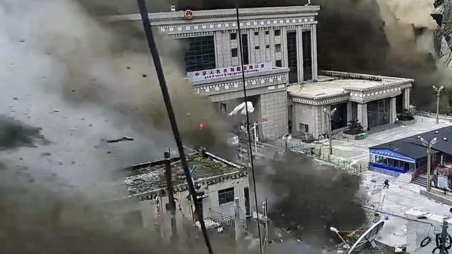 A CCTV footage shows people running away as wall of mud and water destroys buildings in a valley at Nepal-China border, in Gyirong, Tibet region, China August 26, 2026, in this screengrab obtained from a social media video. SOCIAL MEDIA/via REUTERS