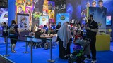 Visitors stand at the Paramount video games booth during the Gamescom video games trade fair at the Trade Fair Center in Cologne, western Germany, on the first day of the fair on August 20, 2025. The 2025 edition of the vast Gamescom trade fair in Co