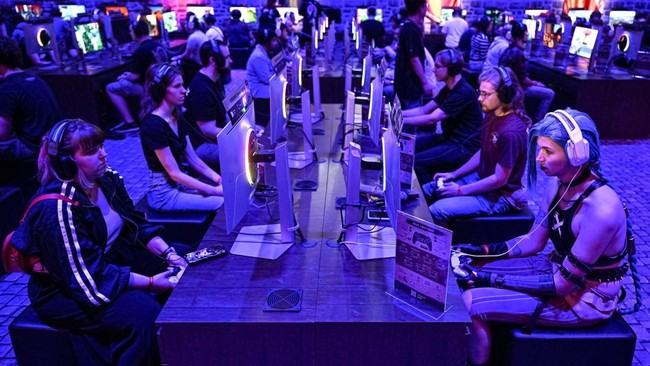 Gamers play the Crimson Desert video game of Pearl Abyss during at the Gamescom video games trade fair at the Trade Fair Center in Cologne, western Germany, on August 21, 2025. The 2025 edition of the vast Gamescom trade fair in Cologne, Germany, had
