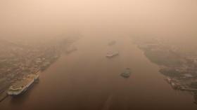 A drone view of ships on the Kapuas river as haze from wildfires blankets the area in Pontianak, West Kalimantan province, Indonesia, August 27, 2026. REUTERS/Willy Kurniawan