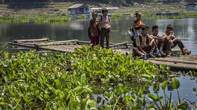 Sejumlah siswa SDN Budiharja menyeberangi perairan Waduk Saguling menggunakan rakit di Cililin, Kabupaten Bandung Barat, Jawa Barat, Jumat (28/8/2026). Sejumlah siswa dan warga dari Kampung Sadang serta Kampung Gombong sejak tahun 1990 terpaksa menye