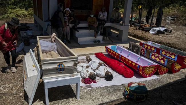 Remains lie on the ground after being removed from the burial chamber during Ma'nene, a Torajan ritual where families exhume, clean and redress their deceased relatives to honour them, in Pangala, North Toraja, South Sulawesi province, Indonesia, Aug