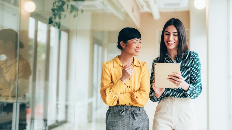 Two businesspeople walking together while discussing new projects&comma; reviewing sales data&comma; and analyzing market opportunities&period; Concept of collaboration&comma; planning&comma; and business growth