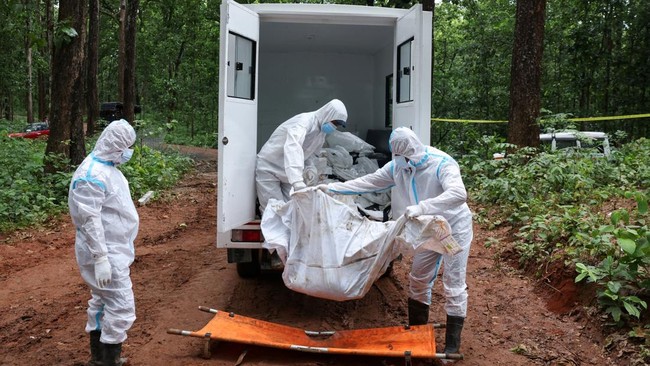Armed Police Force (APF) officers unload a truck of bodies as they transfer them to the pit at Devghat mass burial site for victims of deadly flash floods and mudslides in Chitwan, Nepal, August 31, 2026. REUTERS/Adnan Abidi