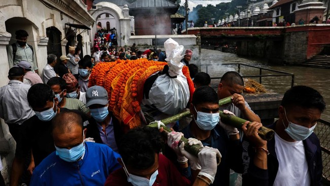 People carry the body of Nakul Sharma, 36, who lost his life in the deadly flash floods and a mudslide, during his cremation rituals on the premises of Pashupatinath Temple in Kathmandu, Nepal, September 1, 2026. REUTERS/Athit Perawongmetha