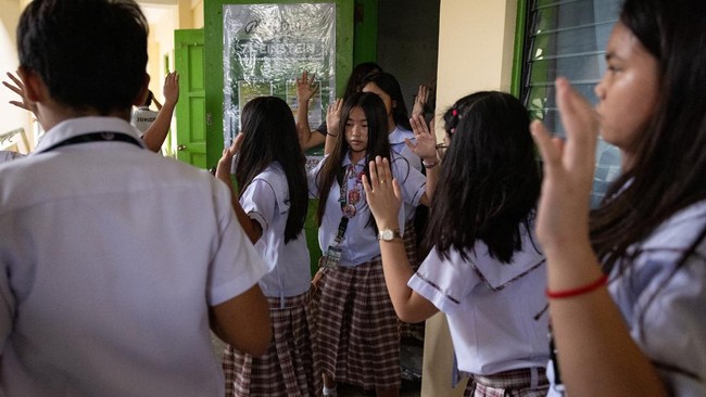 Students walk with their arms raised at the conclusion of an active-shooter drill following recent school shootings in the country, at Carlos F. Gonzales High School in San Rafael, Bulacan, Philippines, September 3, 2026. REUTERS/Eloisa Lopez