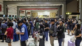 Stranded passengers line up to request refunds after scheduled flights were canceled following the eruption of Mount Anak Krakatoa at Soekarno-Hatta airport in Tangerang on September 6, 2026. The Airport has been temporarily closed to all flight oper