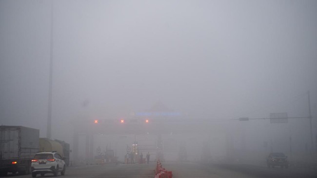 Foto udara sejumlah kendaraan menunggu di gerbang tol Palembang Jalan Tol Trans Sumatera (JTTS) ruas Palembang-Prabumulih yang tertutup kabut asap di Pemulutan, Kabupaten Ogan Ilir (OI), Sumatera Selatan, Minggu (6/9/2026). PT Hutama Karya (Persero)