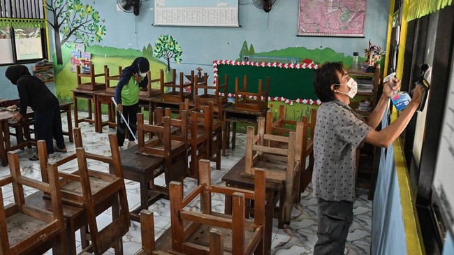 Wali murid membersihkan ruang kelas dari abu vulkanik di SDN Pondok Labu 14 Pagi, Jakarta, Senin (7/9/2026). Pihak sekolah melibatkan komite wali murid untuk membantu membersihkan sekolah dari abu vulkanik akibat erupsi Gunung Anak Krakatau. ANTARA F