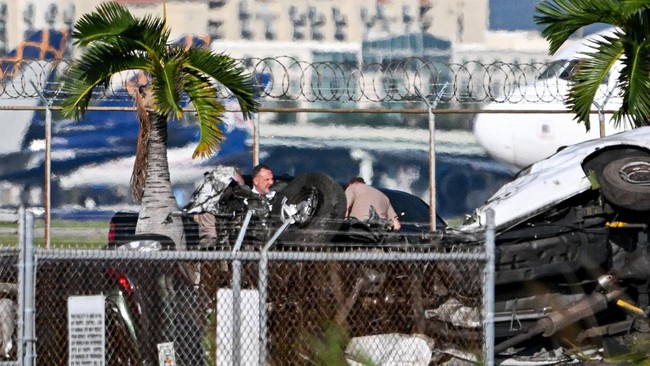 Damaged cars are seen as officials investigate the scene where a Prime Air cargo plane overran the runway and struck vehicles at Miami International Airport in Miami, Florida, on September 6, 2026. At least five people were killed and five more injur