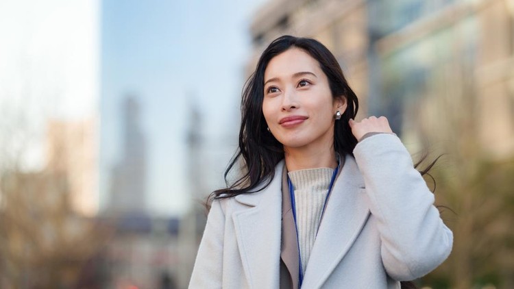 Portrait of a Japanese businesswoman standing outdoors in a modern office district near Tokyo Station&period; Professional woman with a calm and confident expression&comma; surrounded by contemporary city architecture in Tokyo&period;