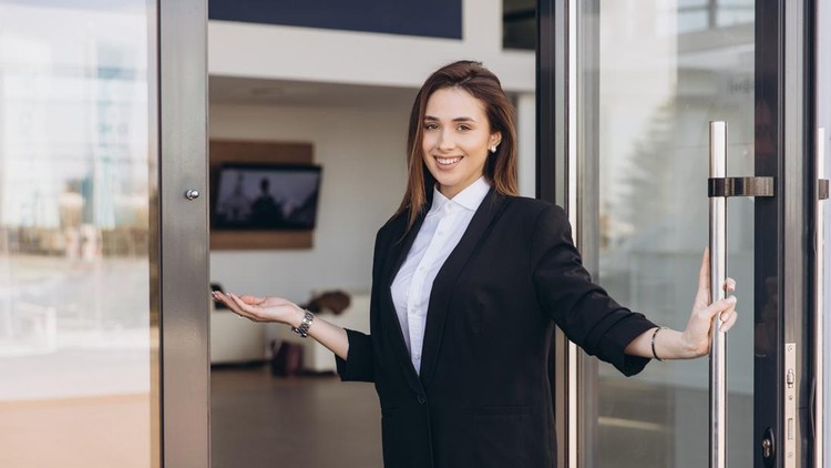 Smiling saleswoman welcoming customers into the dealership&comma; opening the glass door with an inviting gesture and a warm&comma; confident demeanor