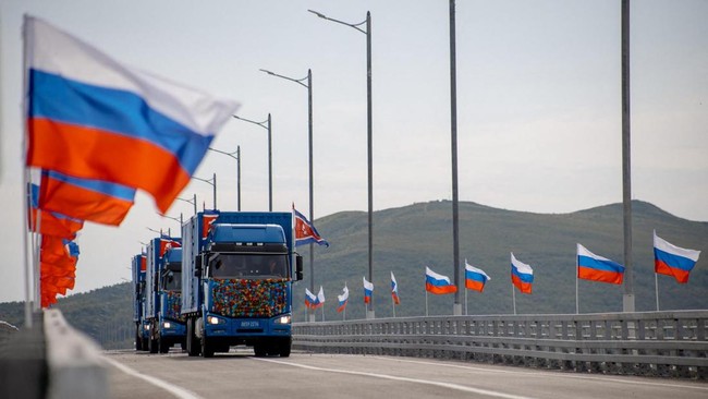 In this handout image released by the Russian Transport Ministry on September 7, 2026, national flags of Russia wave in the wind and North Korean trucks cross the new Russia-North Korea road bridge over the Tumen River, during the opening ceremony. (